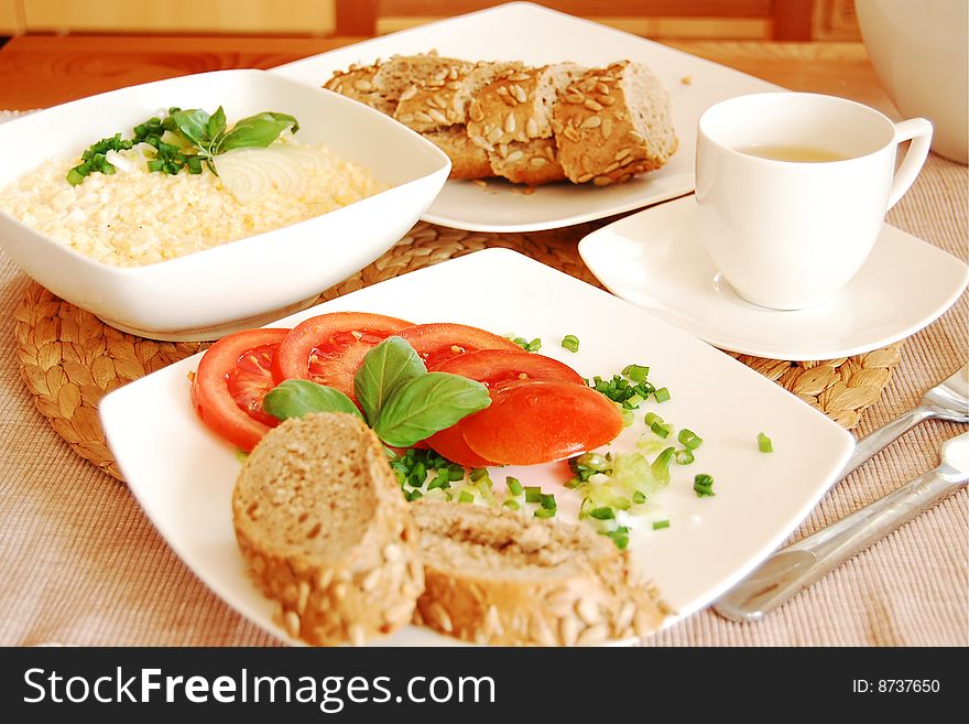 Egg paste and sandwiches with tomatoes, chive and basil leaves and tea