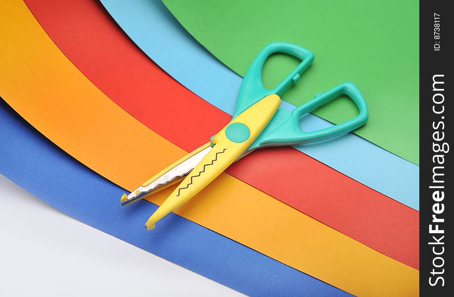 Many colourful paper, cutting out scissors. Many colourful paper, cutting out scissors