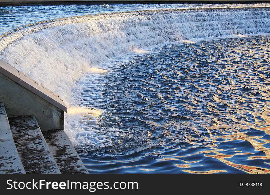 A man made waterfall and pool with late afternoon light. A man made waterfall and pool with late afternoon light.