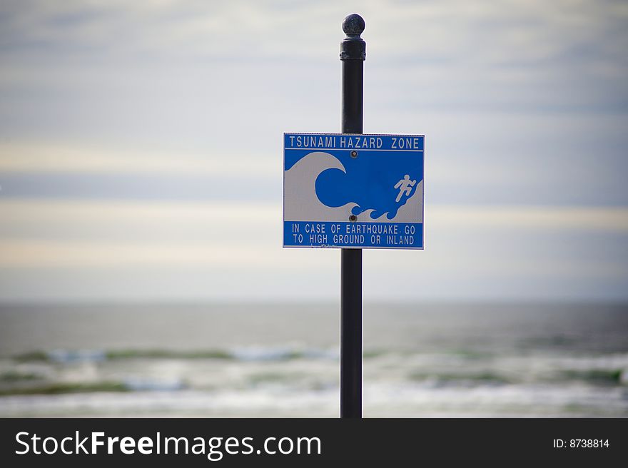 Sign posted at a beach warning of tsunamis. Sign posted at a beach warning of tsunamis