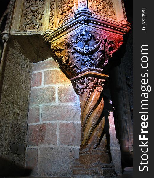 Stone carved pulpit lighted from the stained glass windows. Stone carved pulpit lighted from the stained glass windows