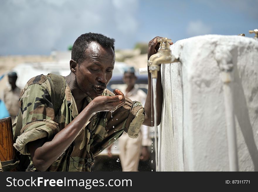 A member of the Somali National Army drinks from a newly opened well donated by the African Union Mission in Somalia to a local community in the country&#x27;s capital of Mogadishu on June 6. AMISOM Photo / Tobin Jones. A member of the Somali National Army drinks from a newly opened well donated by the African Union Mission in Somalia to a local community in the country&#x27;s capital of Mogadishu on June 6. AMISOM Photo / Tobin Jones