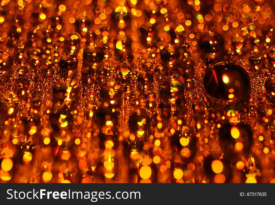 A background of blurred hanging orange glass beads. A background of blurred hanging orange glass beads.