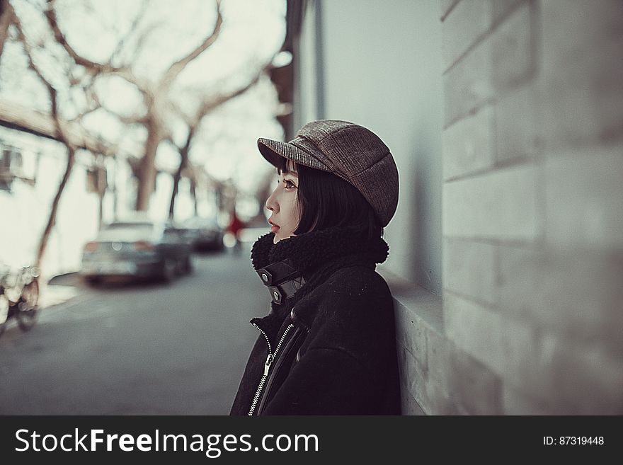 Attractive young woman in urban environment posing in zipped jacket, scarf and fashionable peak cap. Attractive young woman in urban environment posing in zipped jacket, scarf and fashionable peak cap.