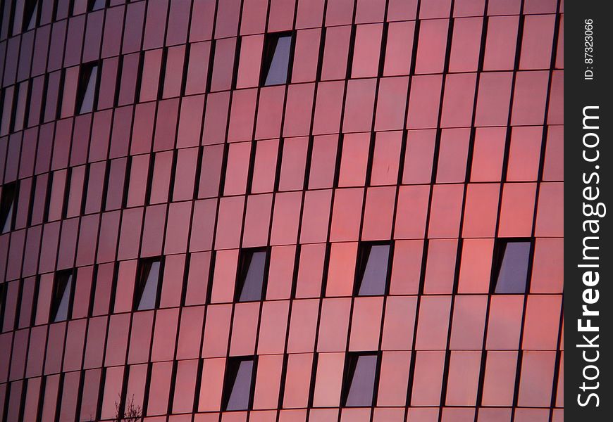 Black Mirror Mounted On Red Wall Building