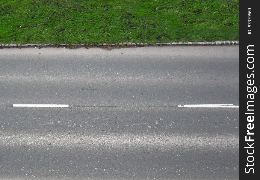 Asphalt And Green Grass