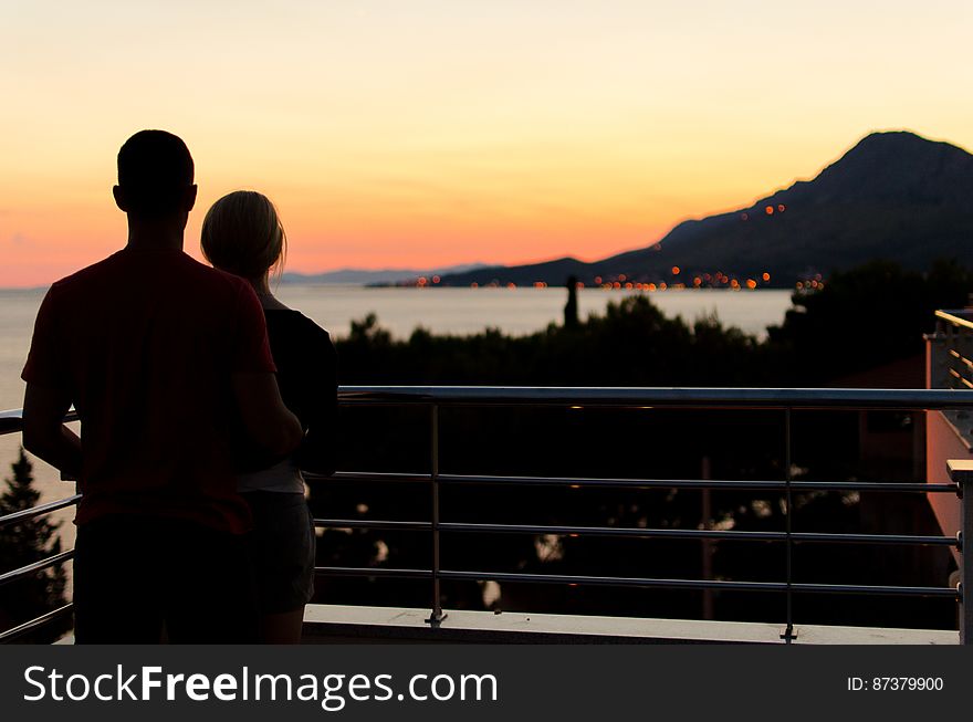 Silhouette Of Couple On Balcony