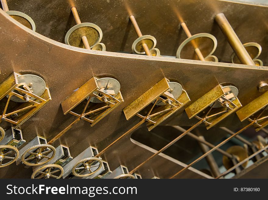 These components perform key computations for Tide Predicting Machine No. 2, a special purpose mechanical analog computer for predicting the height and time of high and low tides. The tide prediction formula implemented by the machine includes the addition of a series of cosine terms. The triangular metal pieces are part of slotted yoke cranks which convert circular motion to a vertical motion that traces a sinusoid. Each slotted yoke crank is connected by a shaft to a pulley, which causes the pulley to follow the sinusoidal motion. A chain going over and under pulleys sums each of their deflections to compute the tide. Along the top of the photo, connecting shafts drive slotted yoke cranks on both sides of the machine. The U.S. government used Tide Predicting Machine No. 2 from 1910 to 1965 to predict tides for ports around the world. The machine, also known as â€œOld Brass Brains,â€ uses an intricate arrangement of gears, pulleys, chains, slides, and other mechanical components to perform the computations. A person using the machine would require 2-3 days to compute a yearâ€™s tides at one location. A person performing the same calculations by hand would require hundreds of days to perform the work. The machine is 10.8 feet &#x28;3.3 m&#x29; long, 6.2 feet &#x28;1.9 m&#x29; high, and 2.0 feet &#x28;0.61 m&#x29; wide and weighs approximately 2,500 pounds &#x28;1134 kg&#x29;. The operator powers the machine with a hand crank. The National Oceanic and Atmospheric Administration &#x28;NOAA&#x29; occasionally displays the machine at its facility in Silver Spring, Maryland. These components perform key computations for Tide Predicting Machine No. 2, a special purpose mechanical analog computer for predicting the height and time of high and low tides. The tide prediction formula implemented by the machine includes the addition of a series of cosine terms. The triangular metal pieces are part of slotted yoke cranks which convert circular motion to a vertical motion that traces a sinusoid. Each slotted yoke crank is connected by a shaft to a pulley, which causes the pulley to follow the sinusoidal motion. A chain going over and under pulleys sums each of their deflections to compute the tide. Along the top of the photo, connecting shafts drive slotted yoke cranks on both sides of the machine. The U.S. government used Tide Predicting Machine No. 2 from 1910 to 1965 to predict tides for ports around the world. The machine, also known as â€œOld Brass Brains,â€ uses an intricate arrangement of gears, pulleys, chains, slides, and other mechanical components to perform the computations. A person using the machine would require 2-3 days to compute a yearâ€™s tides at one location. A person performing the same calculations by hand would require hundreds of days to perform the work. The machine is 10.8 feet &#x28;3.3 m&#x29; long, 6.2 feet &#x28;1.9 m&#x29; high, and 2.0 feet &#x28;0.61 m&#x29; wide and weighs approximately 2,500 pounds &#x28;1134 kg&#x29;. The operator powers the machine with a hand crank. The National Oceanic and Atmospheric Administration &#x28;NOAA&#x29; occasionally displays the machine at its facility in Silver Spring, Maryland.