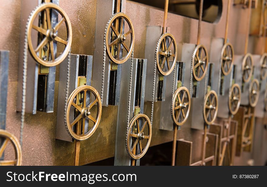 The summation chain runs around pulleys on Tide Predicting Machine No. 2, a special purpose mechanical analog computer for predicting the height and time of high and low tides. The pulleys move up and down and the chain sums their displacements to compute the height or time of high and low tides. The U.S. government used Tide Predicting Machine No. 2 from 1910 to 1965 to predict tides for ports around the world. The machine, also known as “Old Brass Brains,” uses an intricate arrangement of gears, pulleys, chains, slides, and other mechanical components to perform the computations. A person using the machine would require 2-3 days to compute a year’s tides at one location. A person performing the same calculations by hand would require hundreds of days to perform the work. The machine is 10.8 feet &#x28;3.3 m&#x29; long, 6.2 feet &#x28;1.9 m&#x29; high, and 2.0 feet &#x28;0.61 m&#x29; wide and weighs approximately 2,500 pounds &#x28;1134 kg&#x29;. The operator powers the machine with a hand crank.