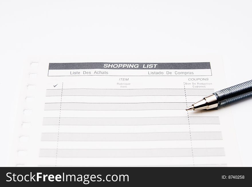 Shoping list with pen isolated on a white background