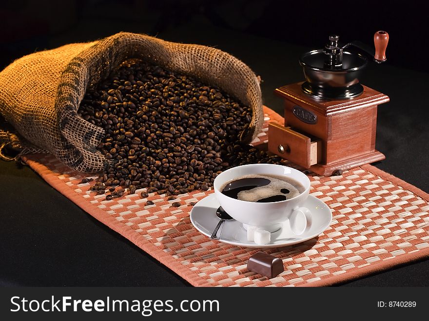 Still life with coffe beans, choc, coffee and coffe grinder. Still life with coffe beans, choc, coffee and coffe grinder