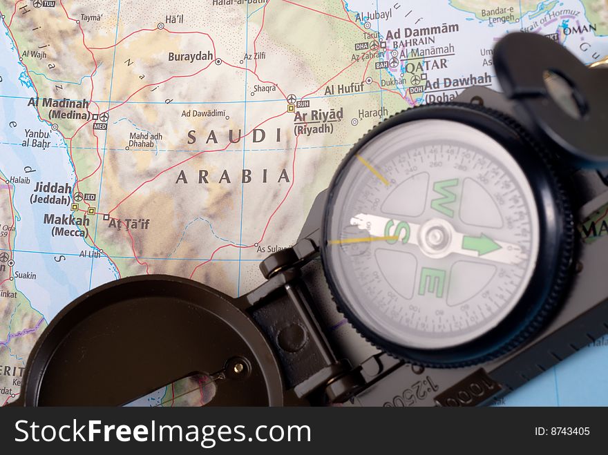 Steel compass on travel map of Saudi Arabia. Steel compass on travel map of Saudi Arabia