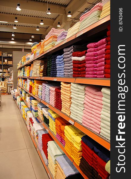 New colorful towels stacks on shelves in store