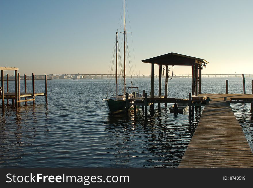 A cruising sailboat waits patiently at the dock. A cruising sailboat waits patiently at the dock.