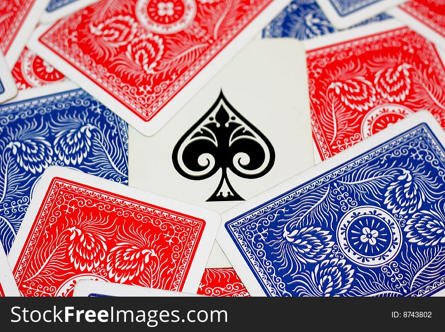 Ace of spades surrounds by red and blue playing cards