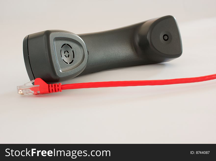VOIP telephone handset with multiple red ethernet cable. VOIP telephone handset with multiple red ethernet cable