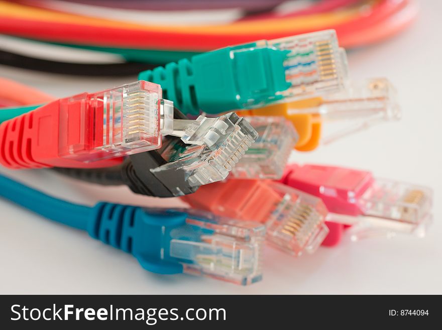 Multiple different colored ethernet cables on white background. Multiple different colored ethernet cables on white background