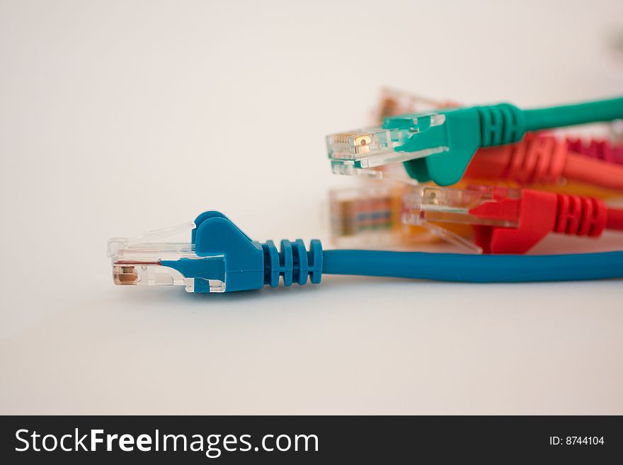 Multiple different colored ethernet cables on a white background. Multiple different colored ethernet cables on a white background