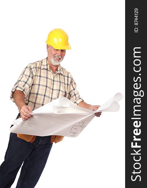 Construction worker in a tool belt and hardhat analyzing blueprints. Construction worker in a tool belt and hardhat analyzing blueprints