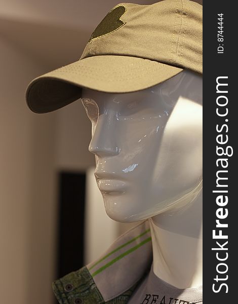 Man mannequin in cap in a shop. Man mannequin in cap in a shop