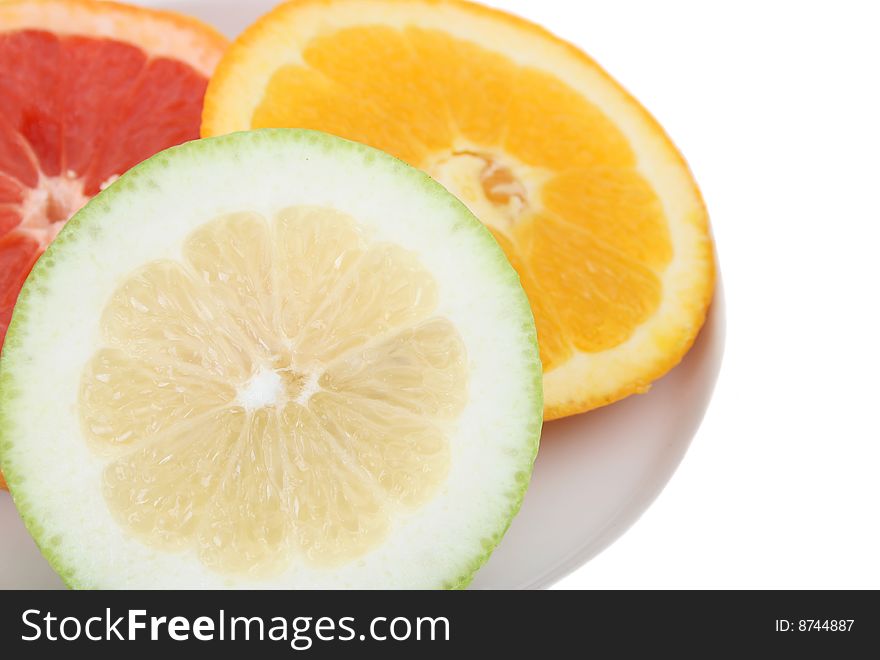 Fresh variety of citrus fruit in a shallow plate. Fresh variety of citrus fruit in a shallow plate