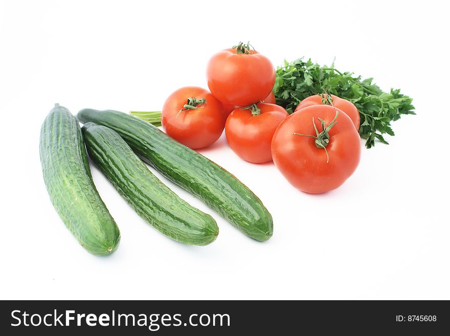 Cucumbers and tomatoes over white background