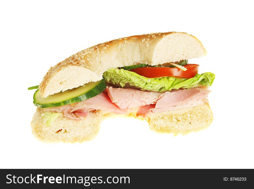 Half a bagel roll filled with ham and salad. Half a bagel roll filled with ham and salad