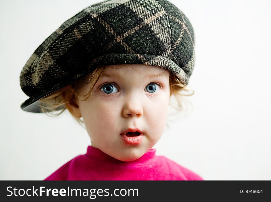 Stock photo: an image of a little nice girl in brown cap