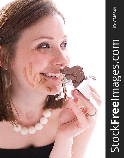 Close-up portrait smiling girl eating a chocolate. Isolated. Close-up portrait smiling girl eating a chocolate. Isolated