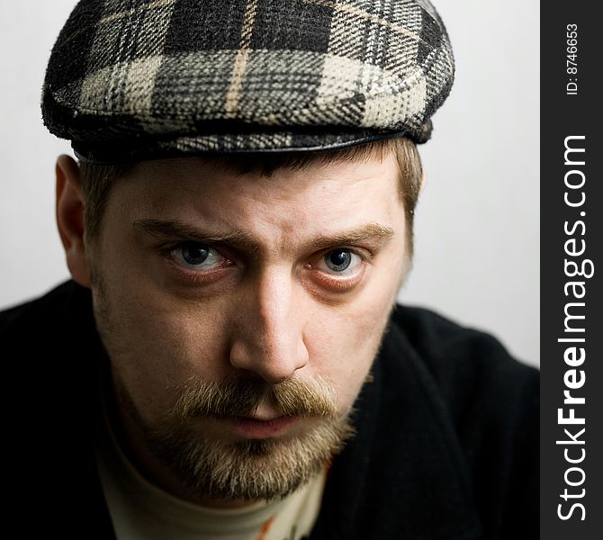 Stock photo: an image of a young man in a cap. Stock photo: an image of a young man in a cap