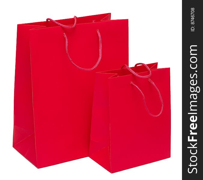 Two red paper bags for shopping on a white background. Studio work. Two red paper bags for shopping on a white background. Studio work.