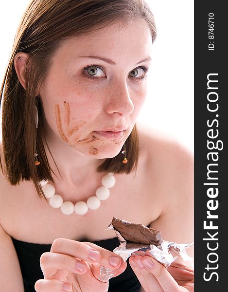 Closeup portrait of woman eating a chocolate. Isolated. Closeup portrait of woman eating a chocolate. Isolated