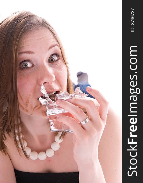 Closeup portrait of woman eating a chocolate. Isolated. Closeup portrait of woman eating a chocolate. Isolated