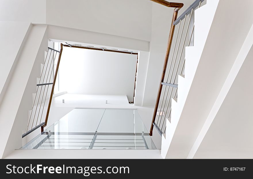 Bright staircase with wooden handhold in public space