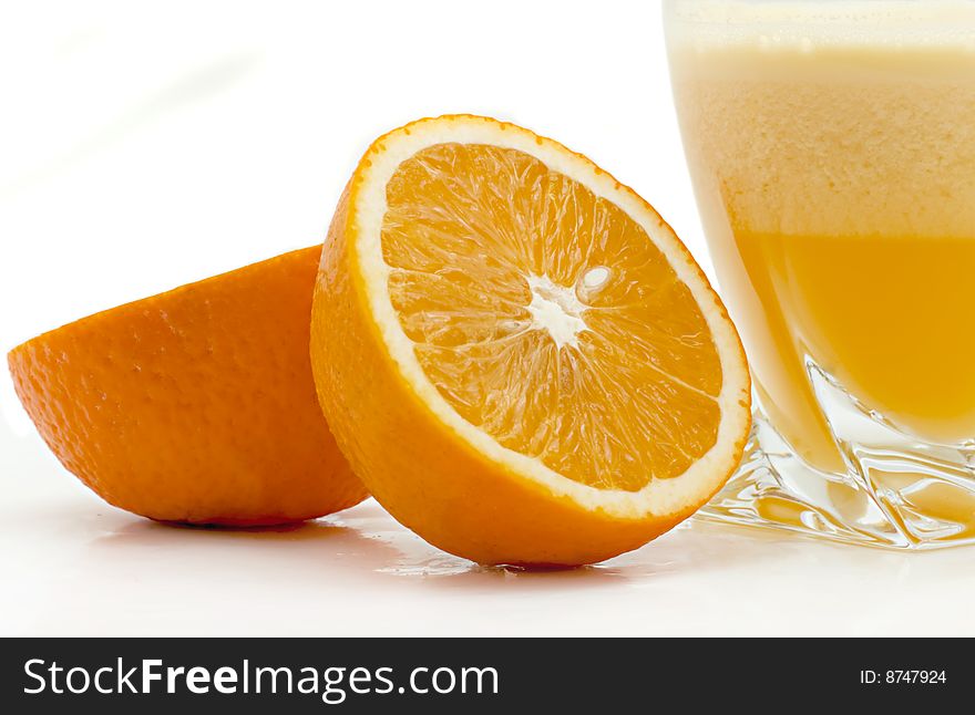 Glass of orange juice and oranges on a white background