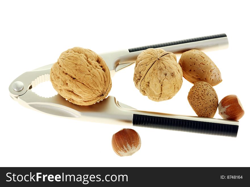 Nutcracker and nuts on a white background. Nutcracker and nuts on a white background.