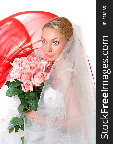 Beautiful young blonde in a veil and roses in hands. Beautiful young blonde in a veil and roses in hands