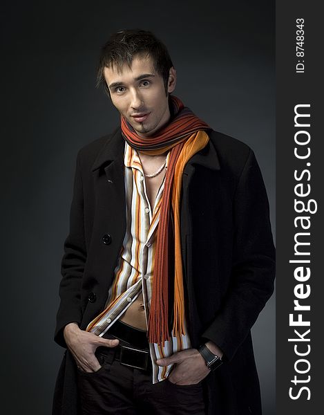 Portrait of a young business man with his hands on a dark background. Portrait of a young business man with his hands on a dark background