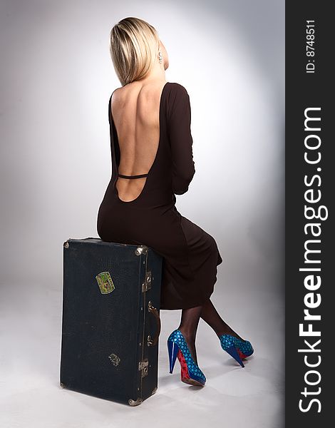 Beauty woman sit on old case