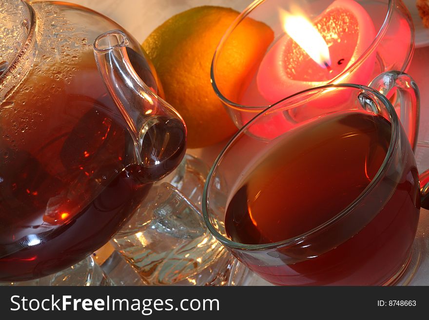 Teapot with cup of tea, jam and fruits. Teapot with cup of tea, jam and fruits.