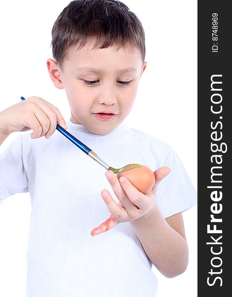 Little boy painting easter egg isolated on white