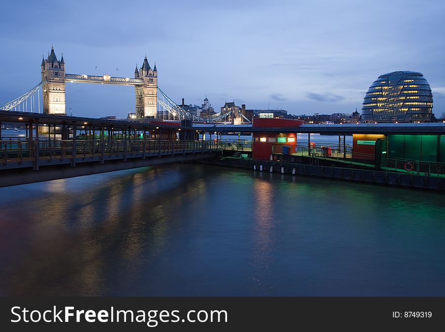 Tower Bridge, Millennium Pier and City Hall on the river Thames at dusk. Tower Bridge, Millennium Pier and City Hall on the river Thames at dusk.