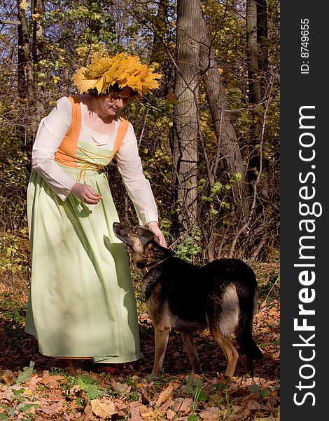 Woman and dog in autumn forest