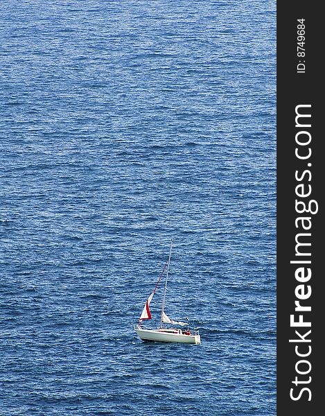 lonely sail boat in open sea. lonely sail boat in open sea