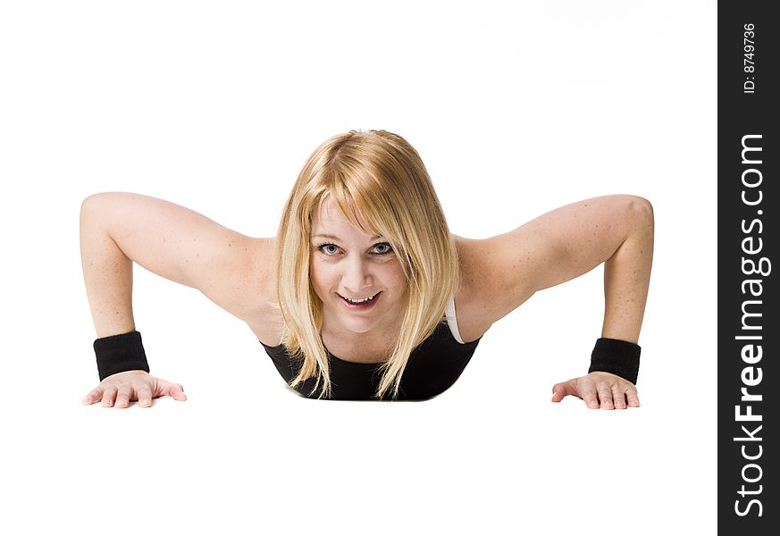 Woman doing push ups towards white background