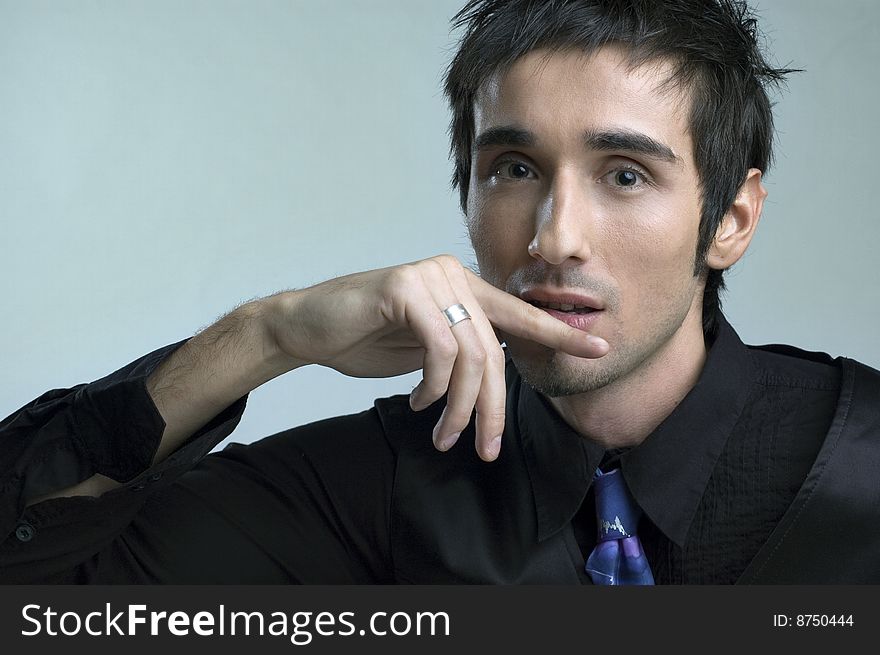 Handsome young man portrait in black suit  in studio