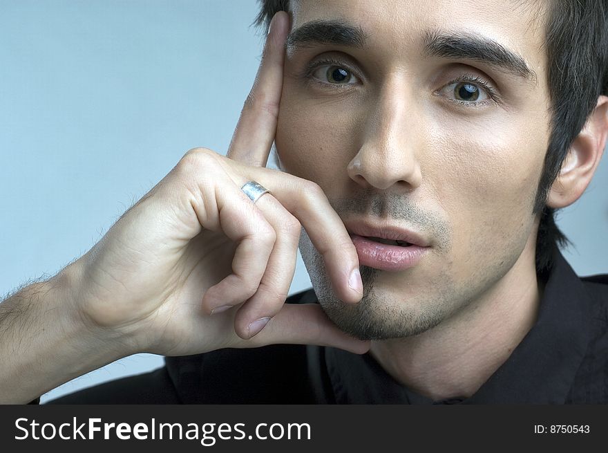 Handsome young man portrait in black suit in studio