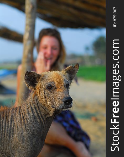 Ugly dog with beautiful blond girl in the background laughing