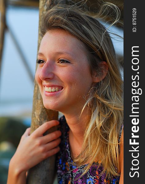 Beautiful young blond girl smiling on beach, showing teeth. Beautiful young blond girl smiling on beach, showing teeth