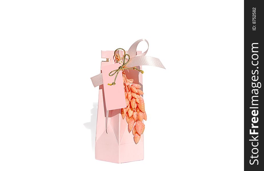 Pink gift box isolated over white whith clipping path. Blank pink tag is included so you can write who the present is for. Pink gift box isolated over white whith clipping path. Blank pink tag is included so you can write who the present is for.